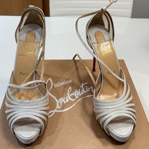 These Authentic Christian Louboutin White Leather Peep Toe Pumps.